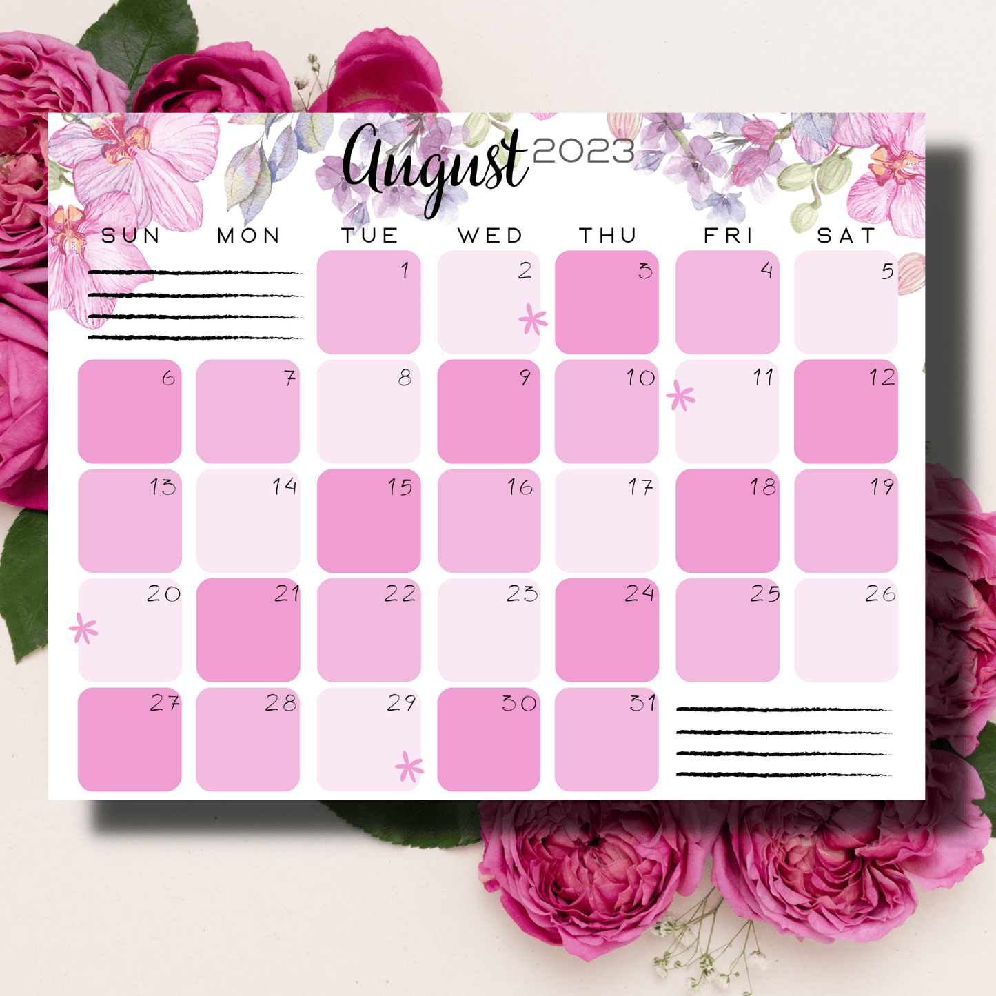 August 2023 children's calendar on a tabletop, adorned with playful pink floral patterns and spaces for notes and planners.