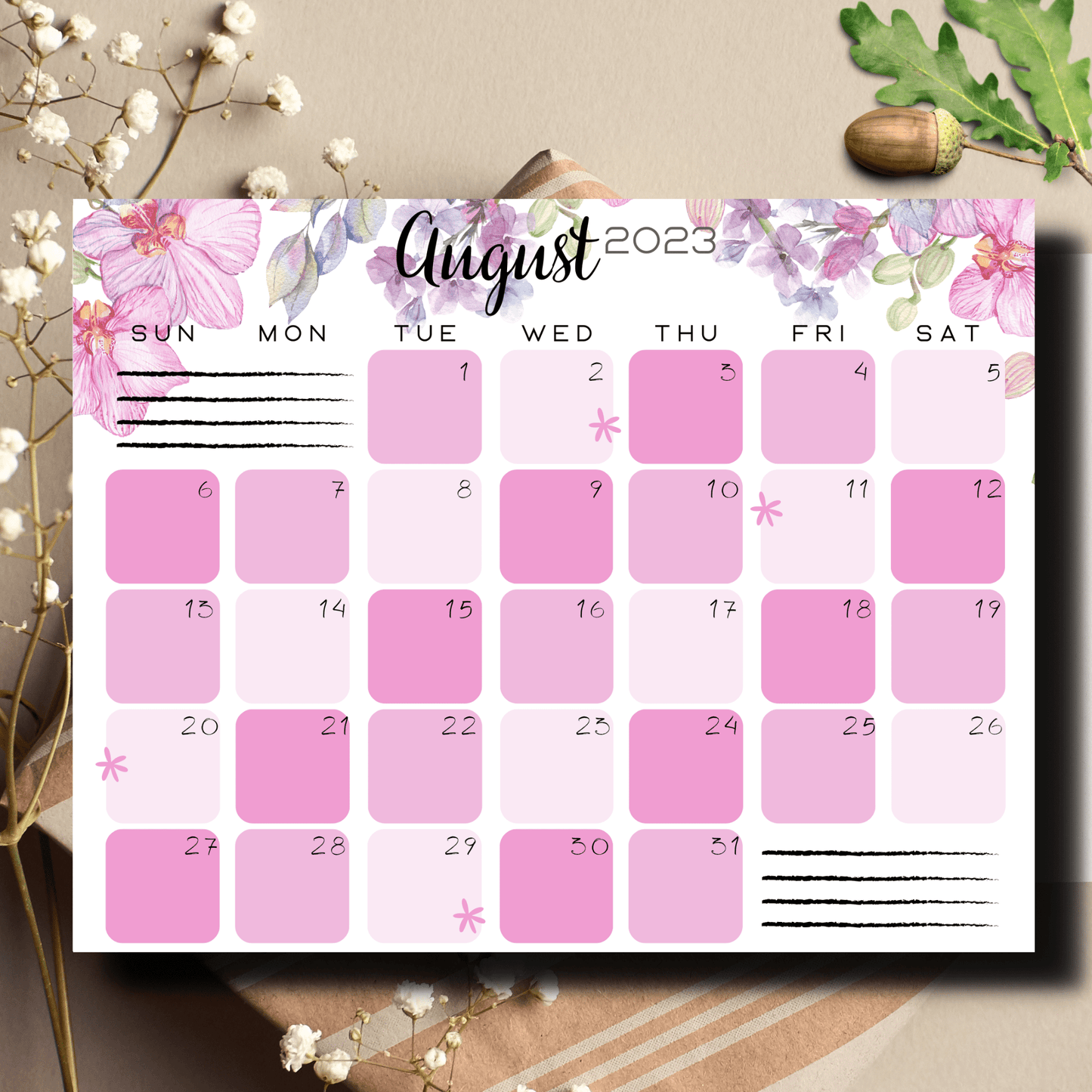 August 2023 children's calendar on a tabletop, adorned with playful pink floral patterns and spaces for notes and planners.