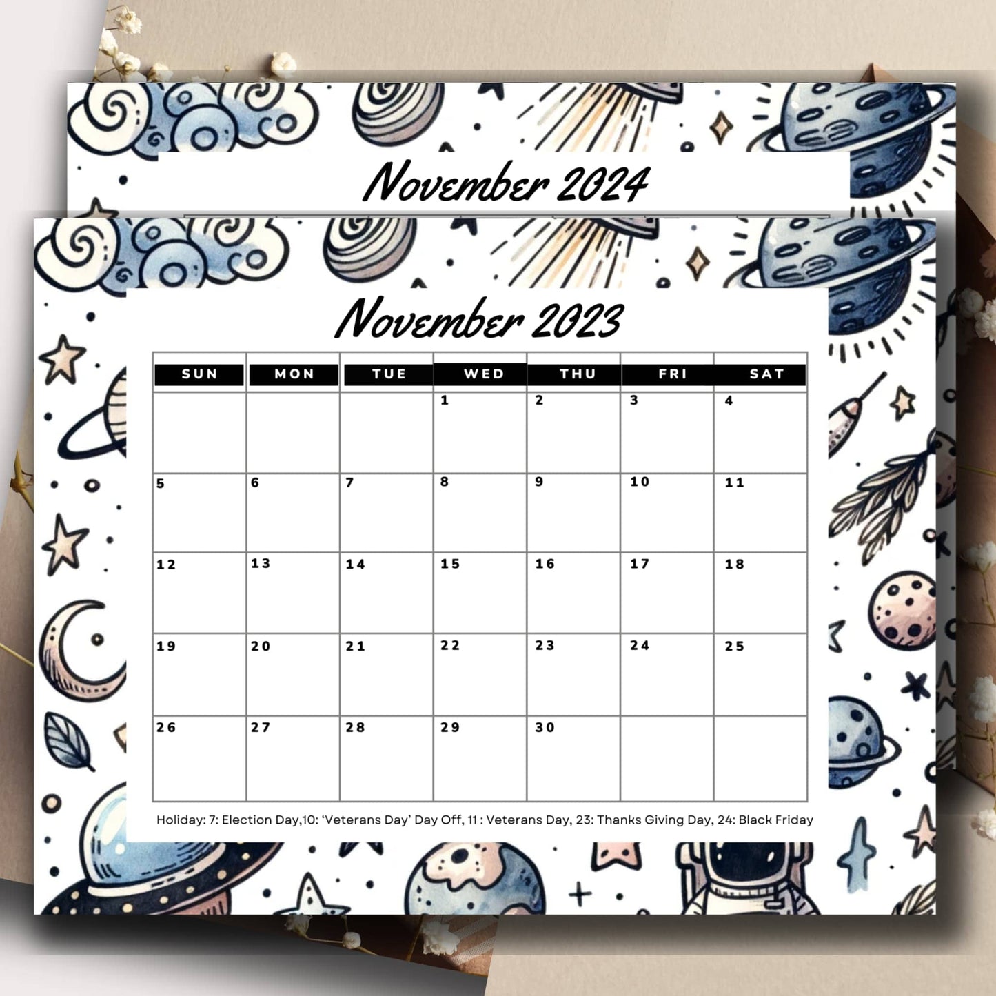 November 2023 & 2024 space-themed calendar sheet presented with an envelope and decorative flowers.
