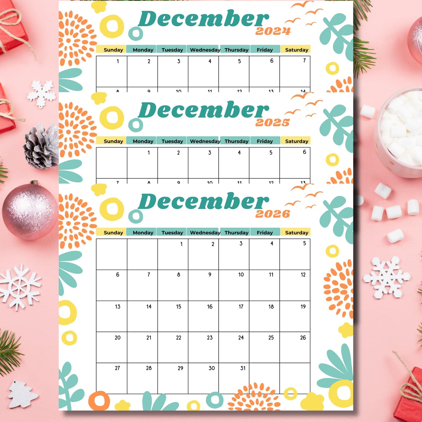 Three-year December calendar set with festive turquoise and orange floral design, displayed with holiday decorations including pinecones, snowflakes, and pine branches on pink background.