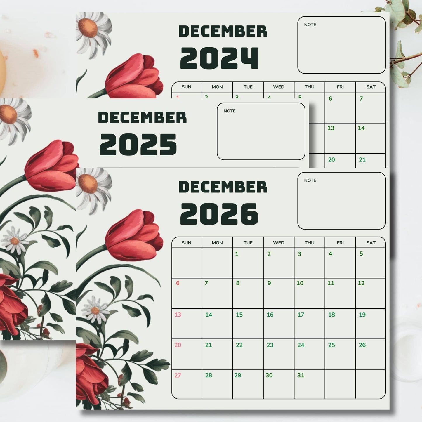 Close-up of December calendars showing elegant floral design with red tulips and white daisies, featuring note sections and dated grid
