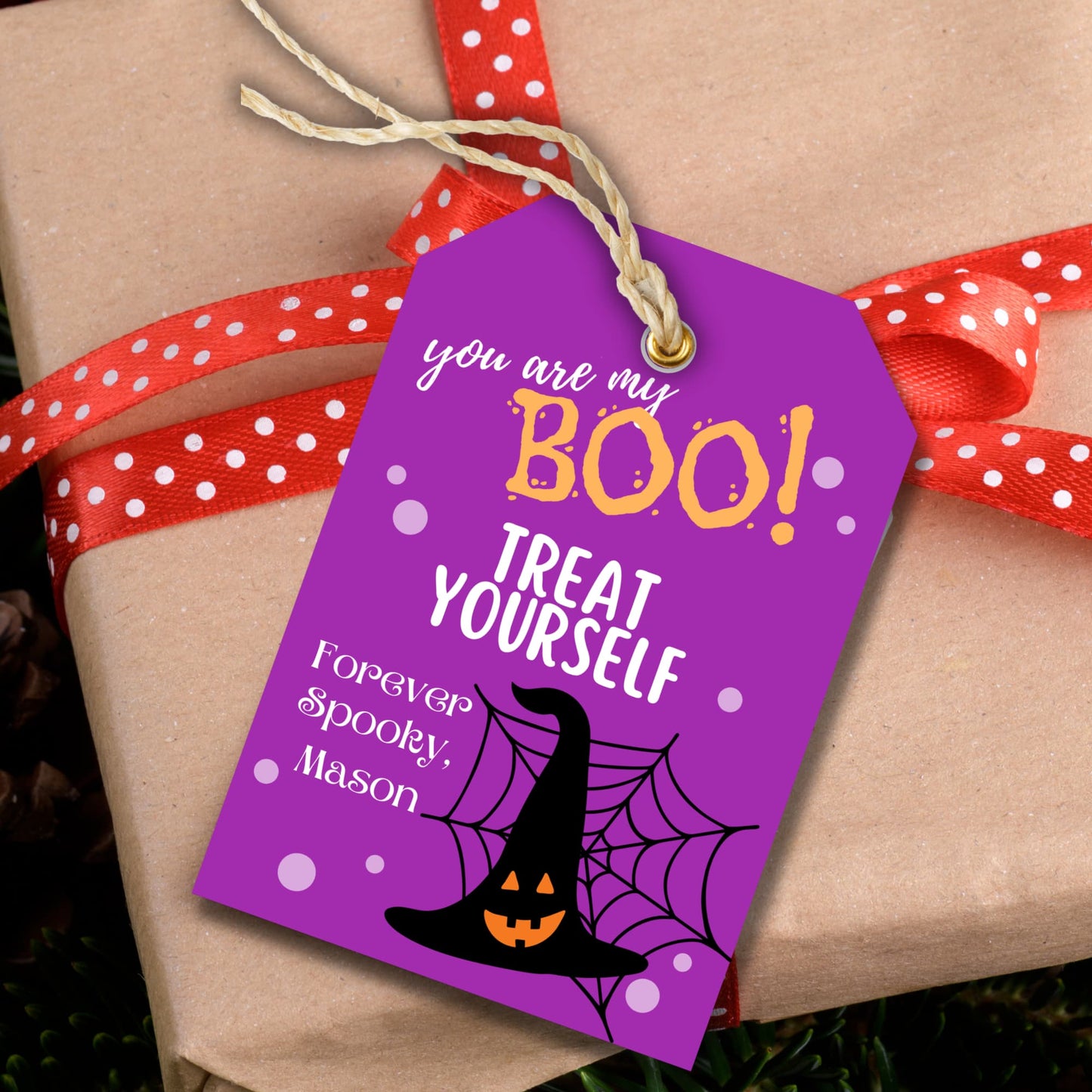 Halloween printable tag showcased on a brown gift box.
