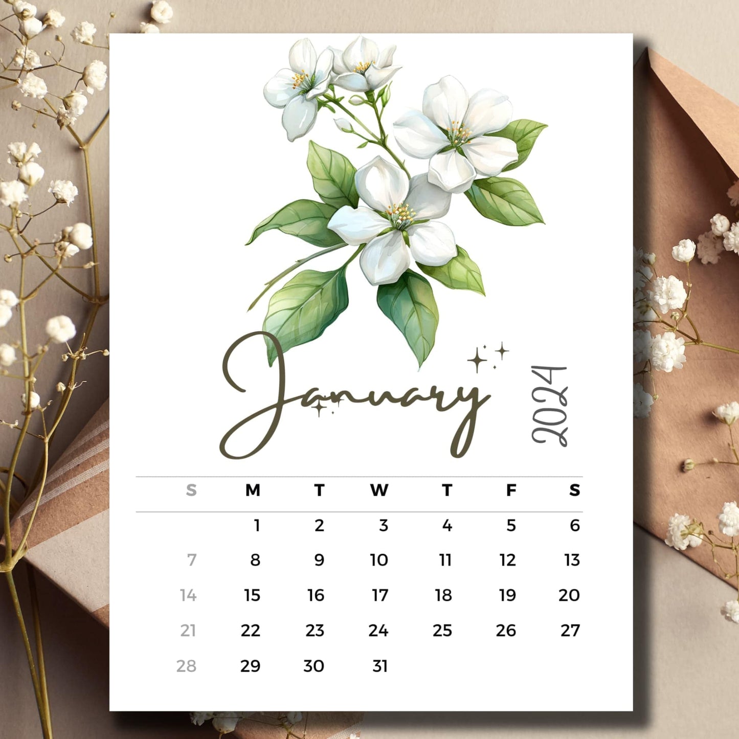 January 2024 Jasmine Symphony full year calendar on a table with an envelope and small white flowers.
