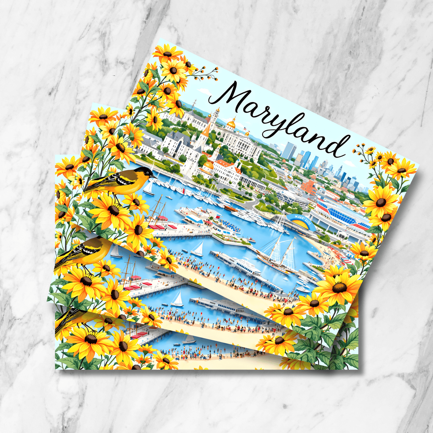 Stack of Maryland watercolor prints displayed on marble background featuring Baltimore cityscape with harbor view, Black-Eyed Susan flower border, and Baltimore Oriole birds. From the State Symbols Collection.