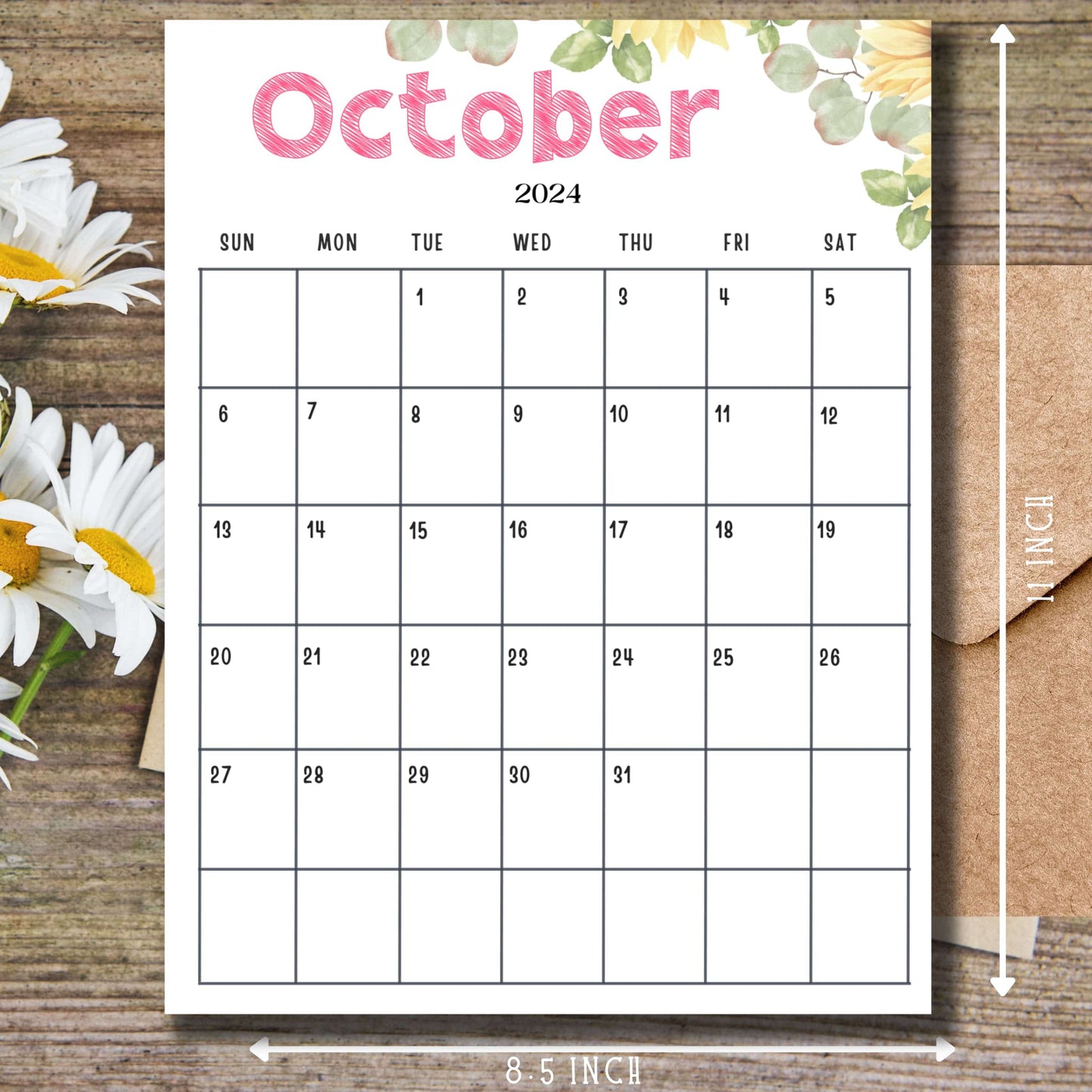 Close-up of October 2024 calendar page with pink header and green leaf design, displayed on wooden surface with daisy flowers, emphasizing 8.5 x 11 inch size.