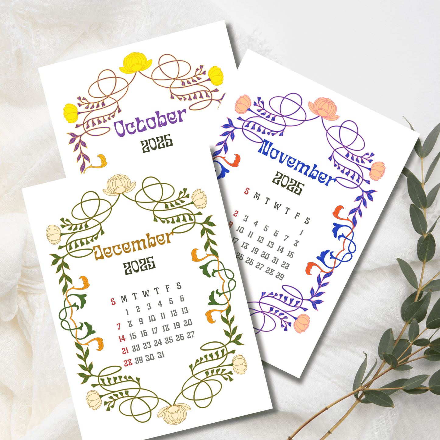 Late autumn and winter 2025 calendar pages showcasing seasonal colored Art Nouveau borders with lotus flowers, displayed with eucalyptus sprig