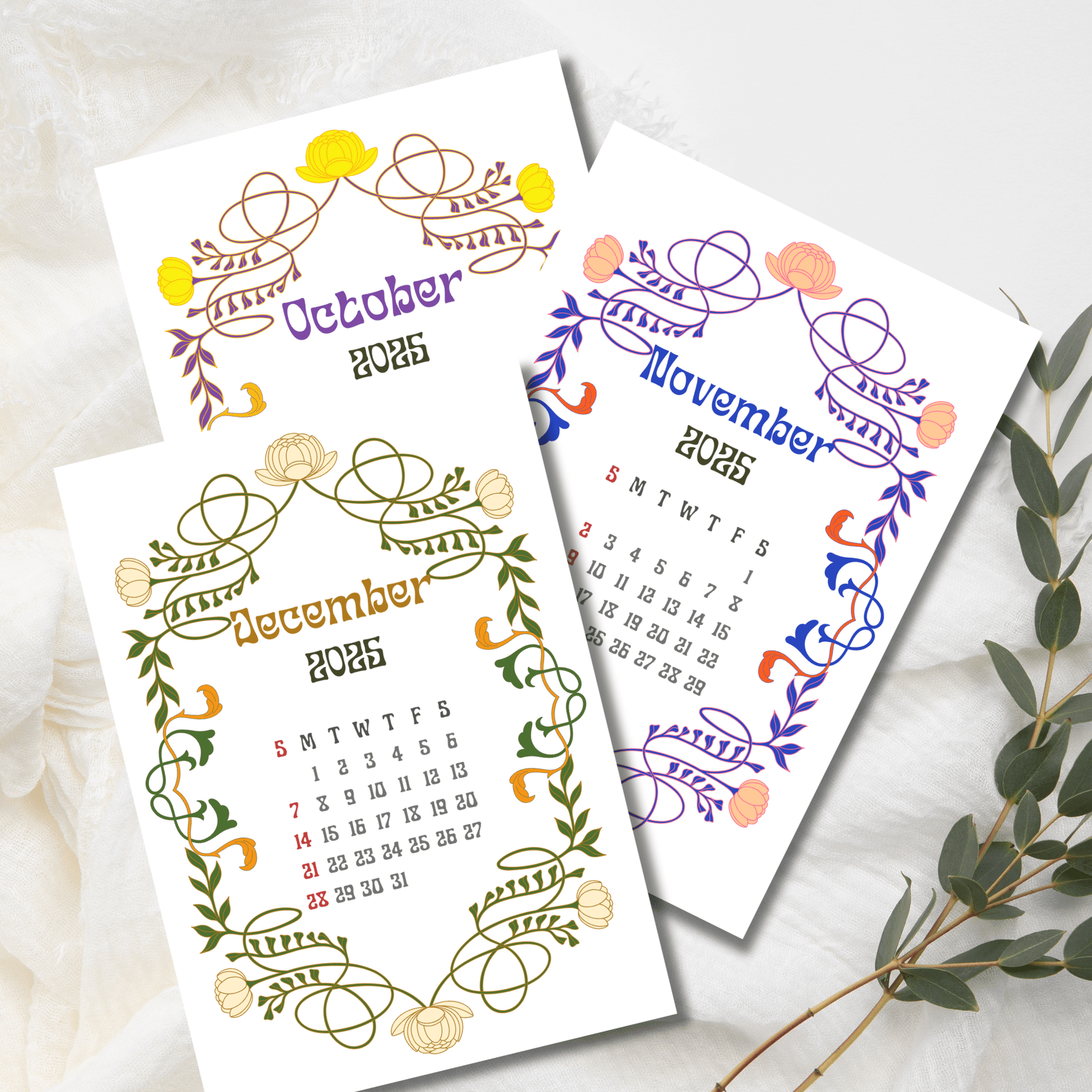 Late autumn and winter 2025 calendar pages showcasing seasonal colored Art Nouveau borders with lotus flowers, displayed with eucalyptus sprig