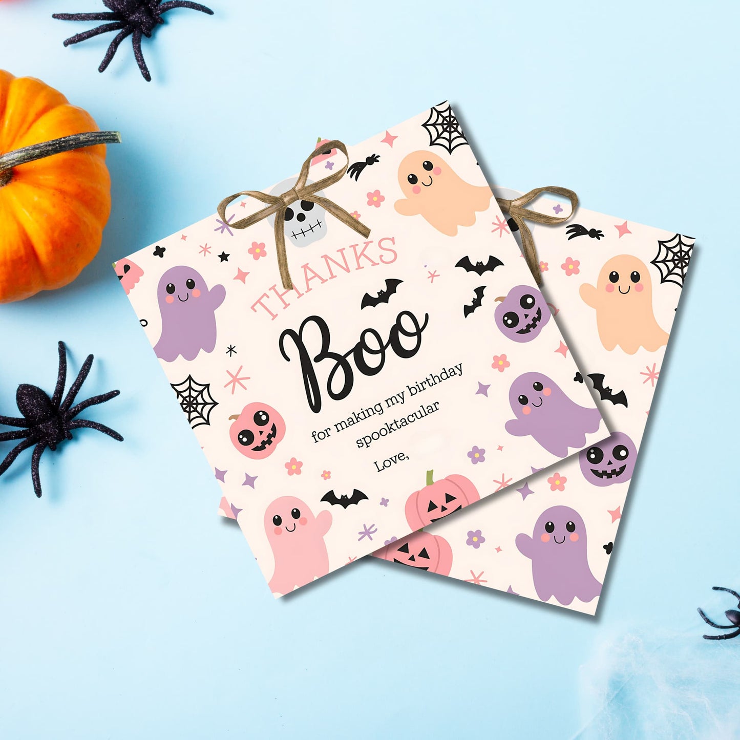 Cute "Thanks Boo" Halloween birthday gift tags with pastel ghosts and jack-o'-lanterns, arranged on light blue background with spooky decor