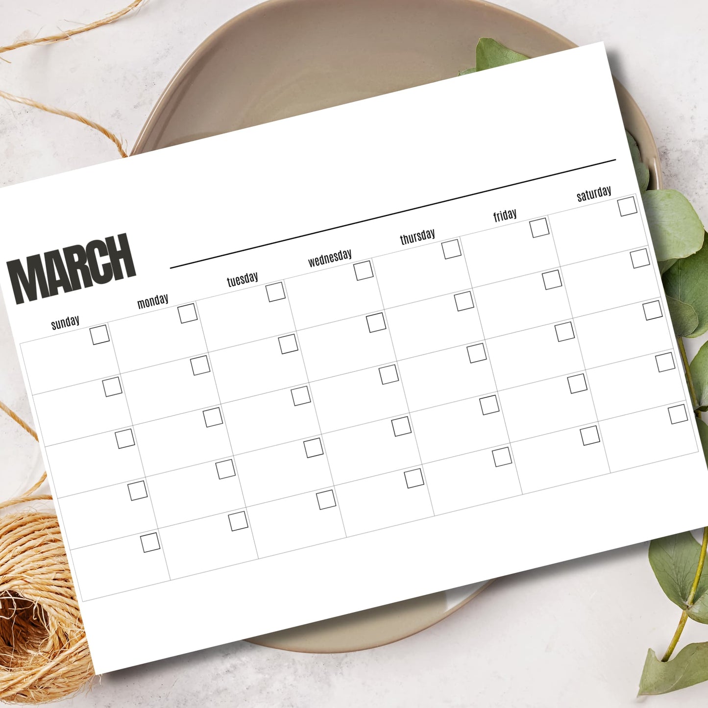 Printable March planner PDF A4 size monthly productivity organizer displayed in ceramic bowl with leaves