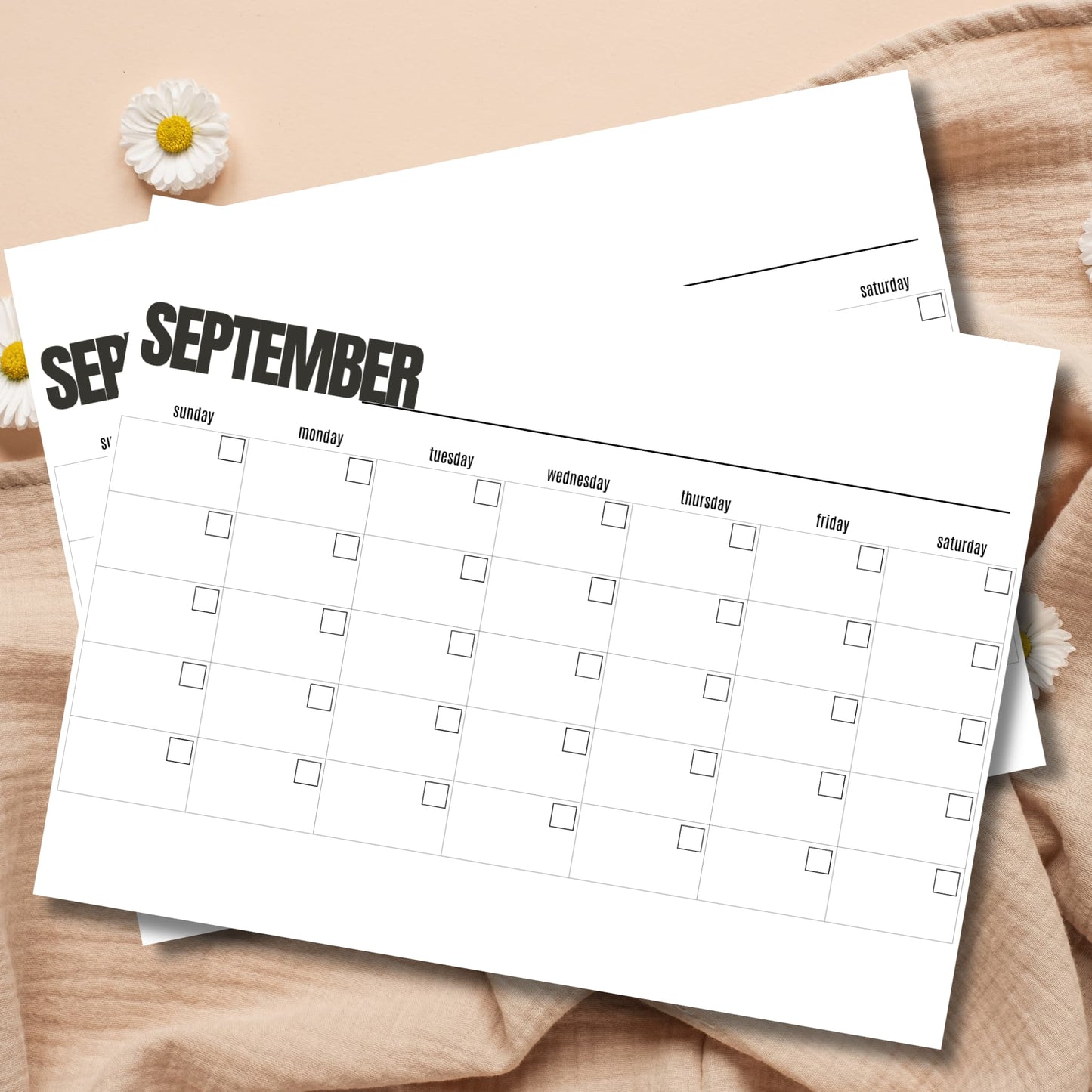 September monthly planner template on wooden surface with white daisies and natural styling