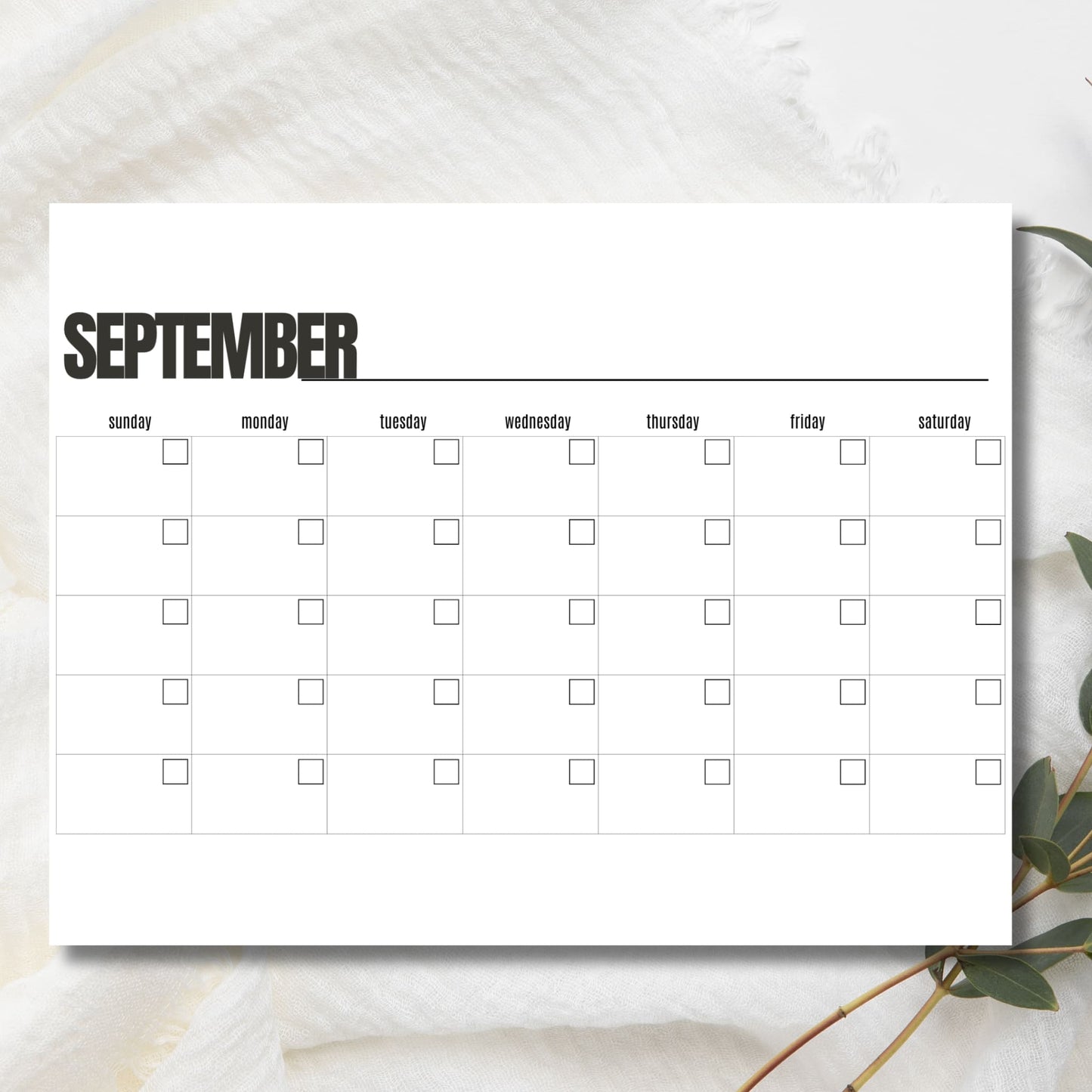 Clean September calendar layout on marble surface showing weekly grid format