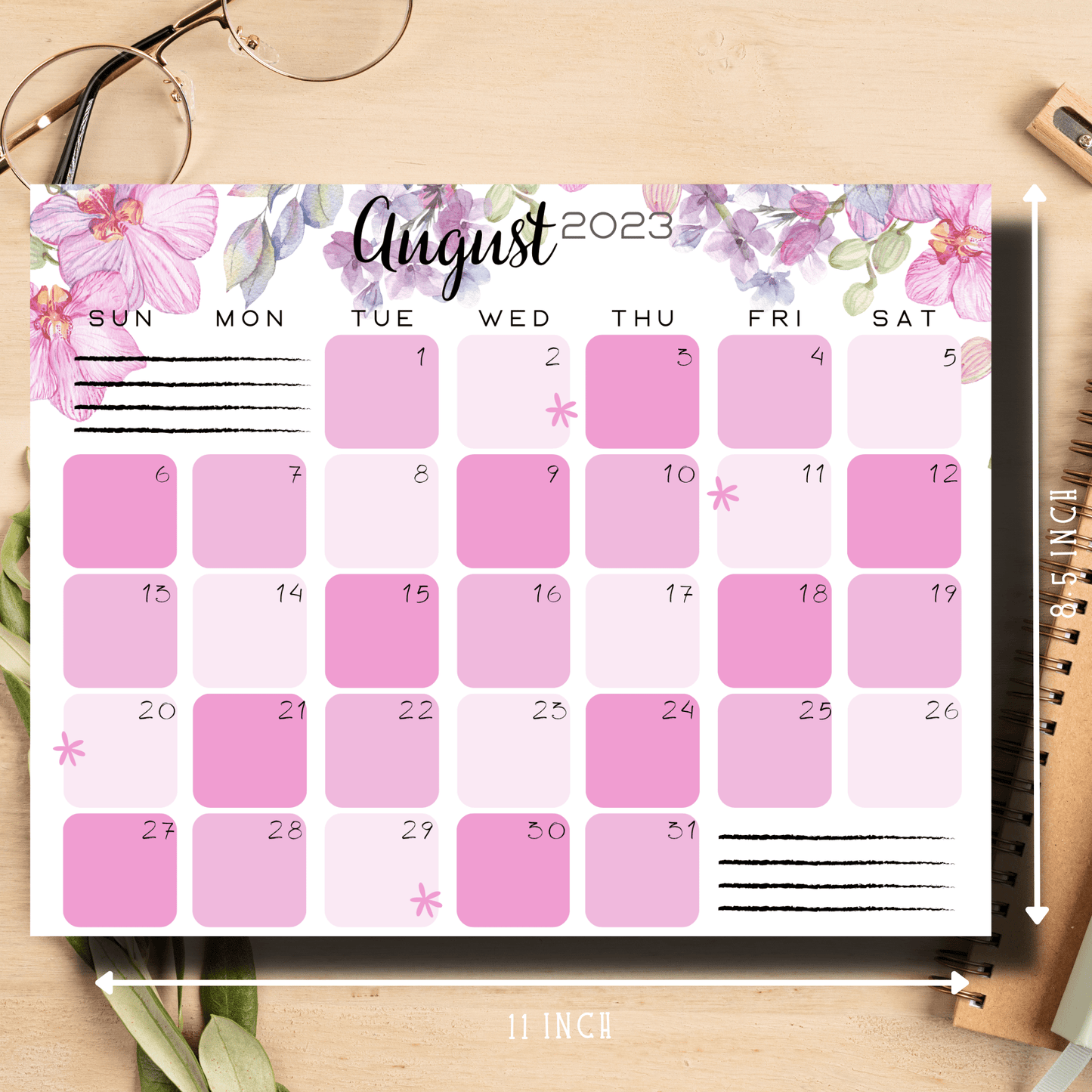 Printable school calendar for August 2023 with pink floral accents, neatly placed on a table, ready for planning and jotting down events.