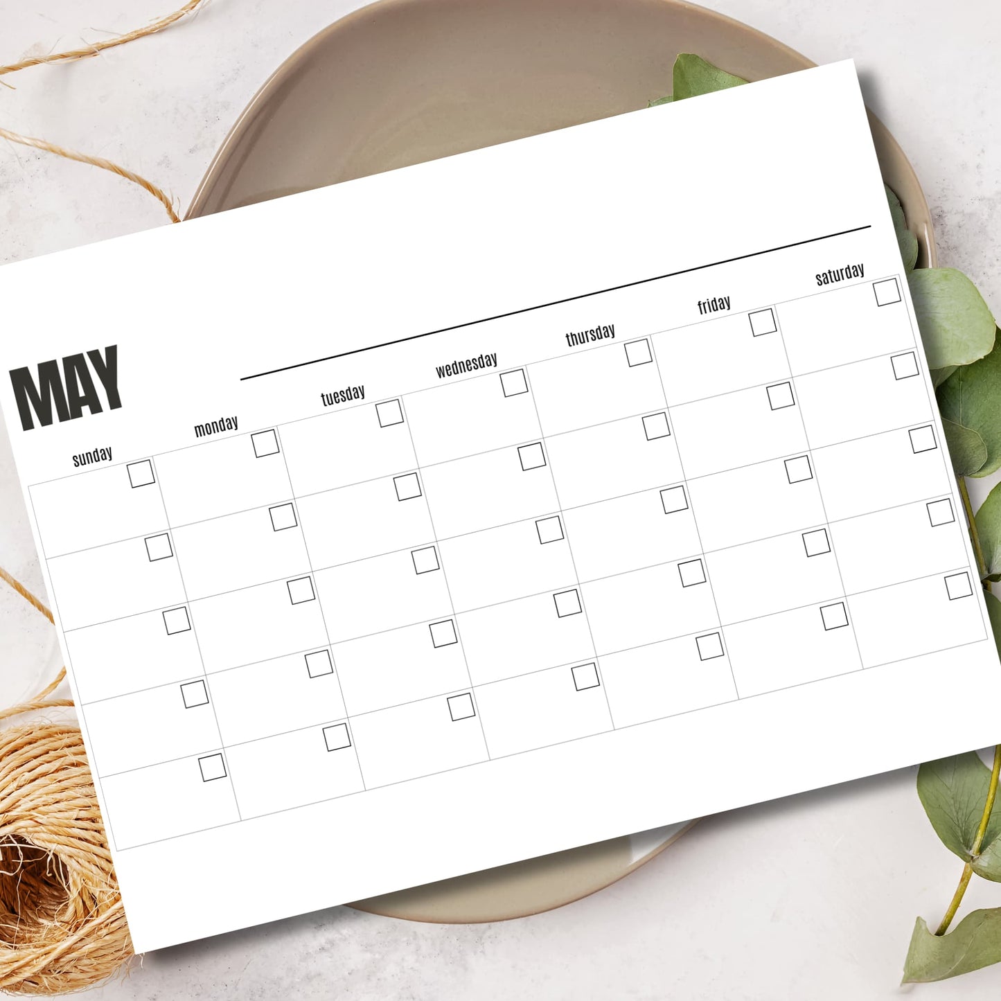 Undated PDF planner for digital download A4 size May calendar displayed in ceramic bowl with leaves