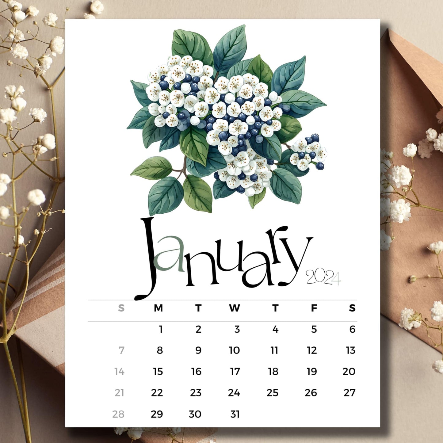 Viburnum Vision January 2024 full year calendar on a table with an envelope and small white flowers.