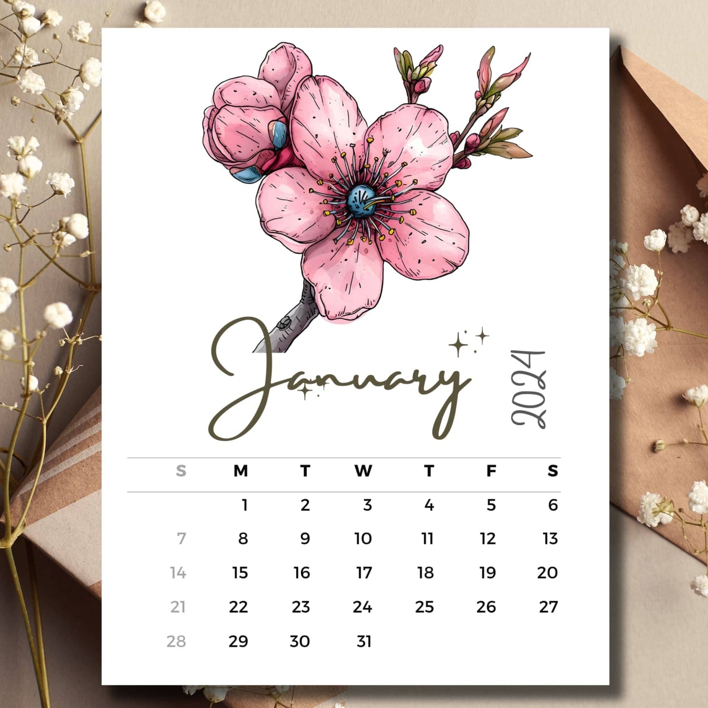 Winter Cherry January 2024 full year calendar on a table with an envelope and small white flowers.