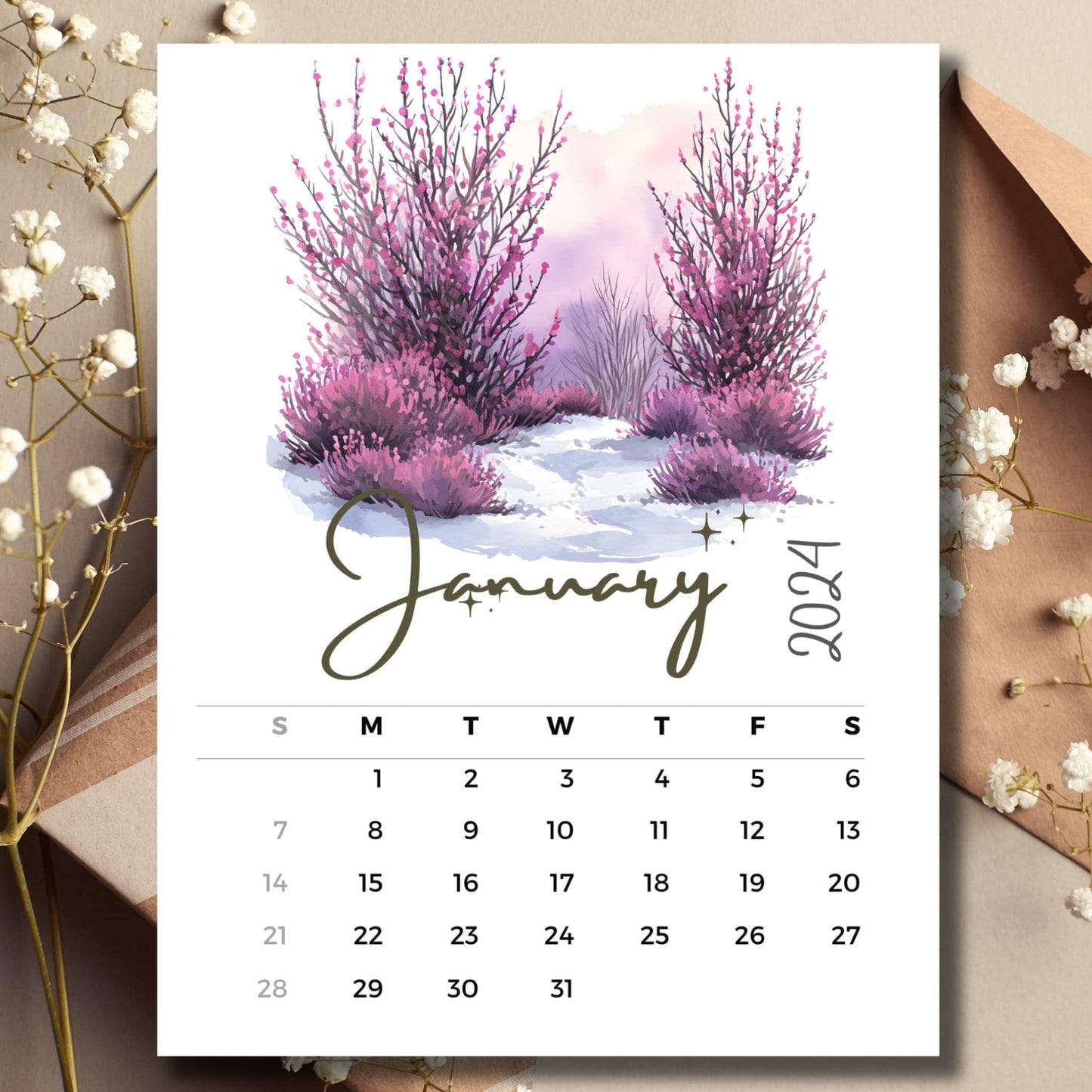 Winter Heather January 2024 full year calendar on a table with envelope and small white flowers.