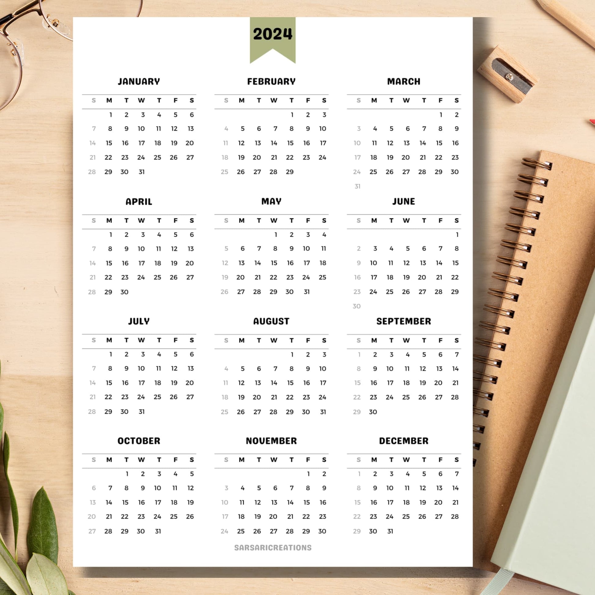 Minimalist 2024 calendar page on light brown wooden desk with school supplies like notebook, pencil, sharpener.