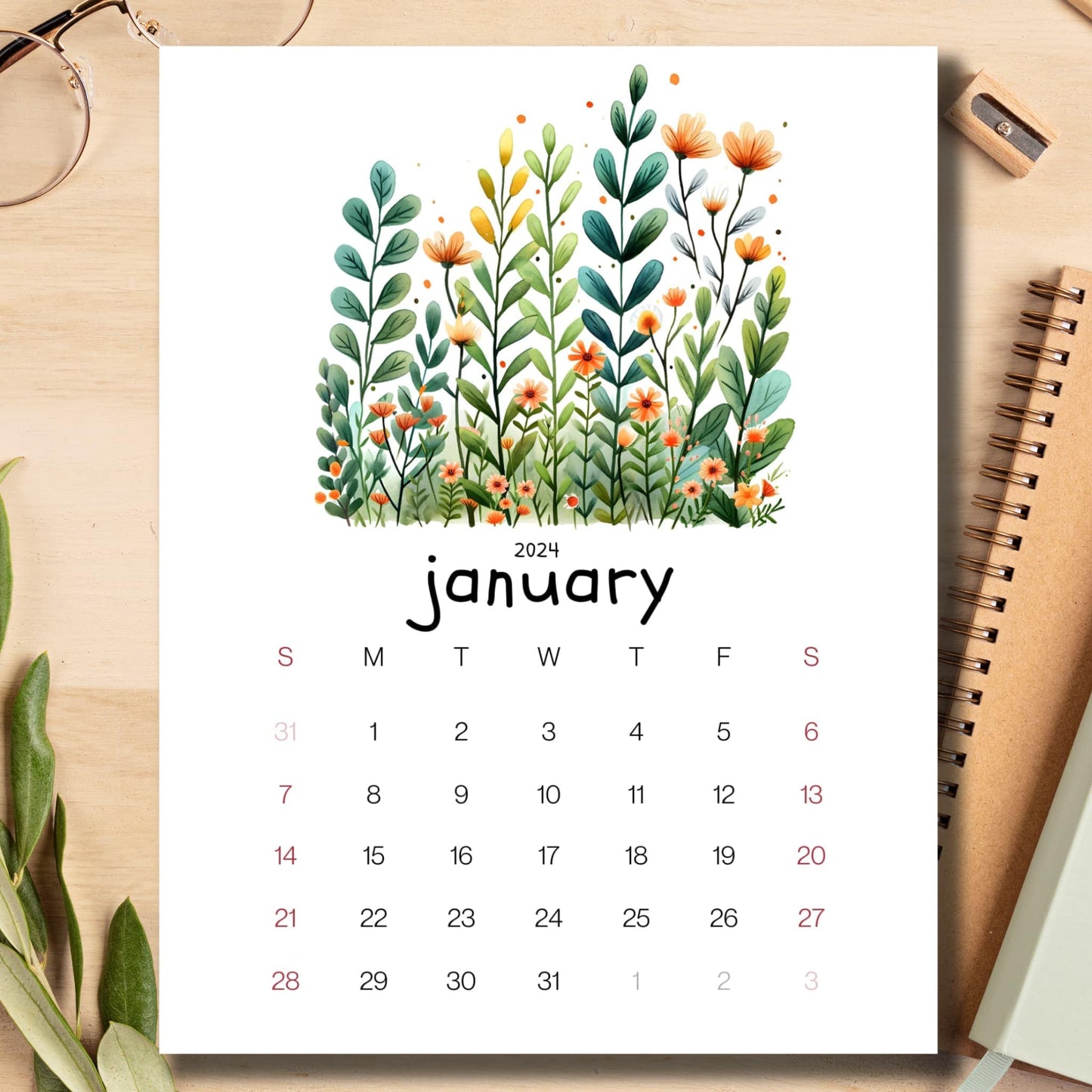 Evergreen Embrace January 2024 calendar displayed on a light brown wooden desk with school supplies like notebooks, pencils, and sharpeners.
