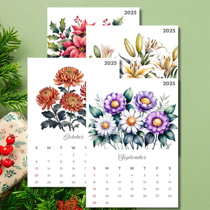 2025 calendar pages featuring September and October with watercolor illustrations of poinsettias, chrysanthemums, lilies, and purple daisies, elegant script typography on white background