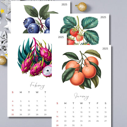 2025 calendar displaying January and February months featuring botanical illustrations of oranges, blueberries, dragon fruit, and strawberries, decorated with holiday ornaments