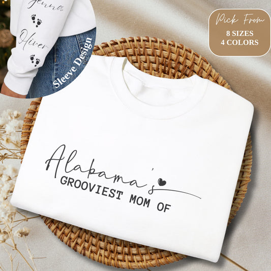 Folded Alabama Custom Mom Crewneck Gildan Sweatshirt on a beige background, showcasing sleeve design with kids' names.