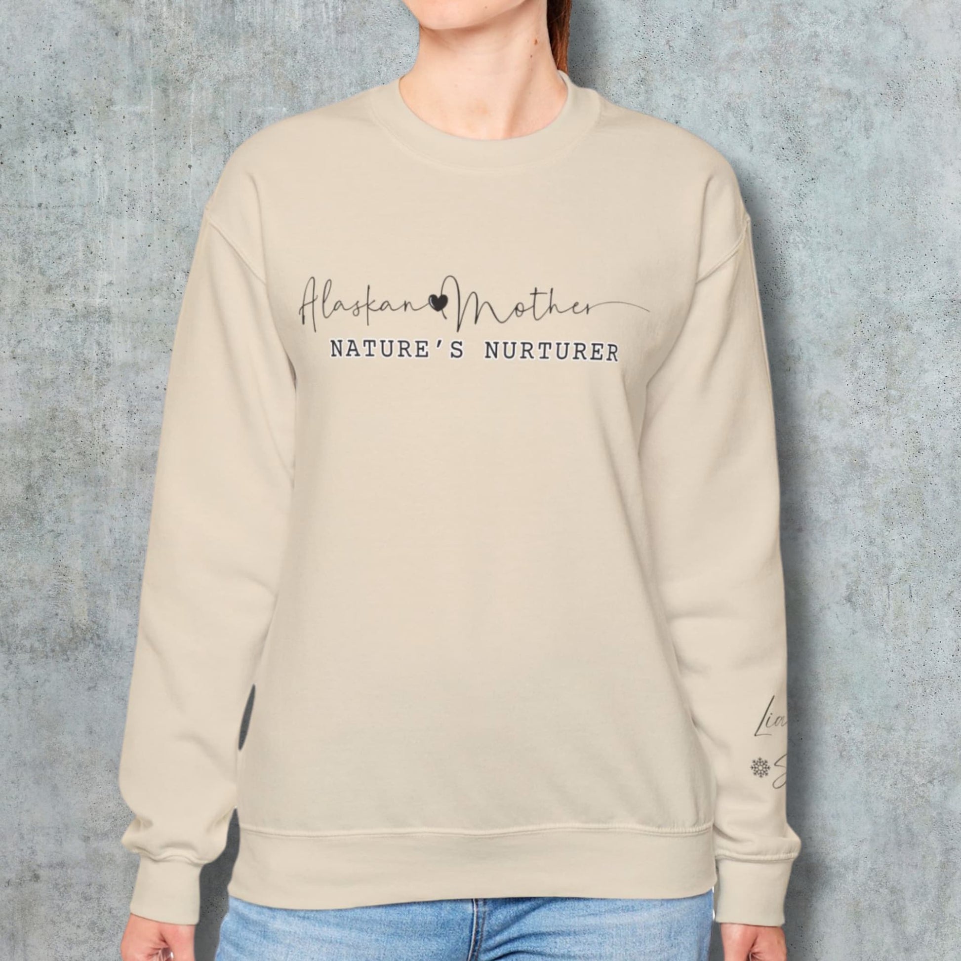 Woman modeling the Alaskan Mother Personalized Crewneck Sweatshirt against a wall background, showcasing the comfortable fit and style.