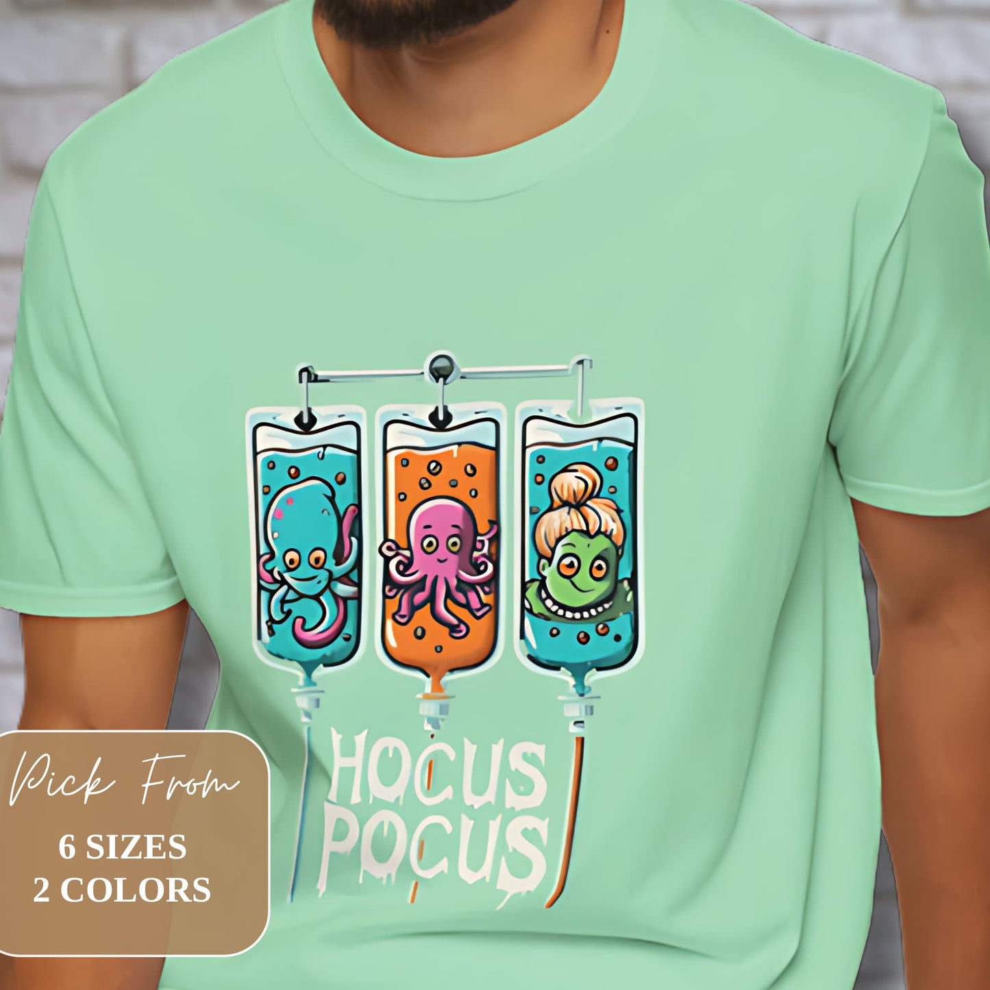 Mint green t-shirt with 'Hocus Pocus' design featuring three IV bags containing cute octopus, squid, and mermaid characters. Available in 6 sizes and 2 colors.