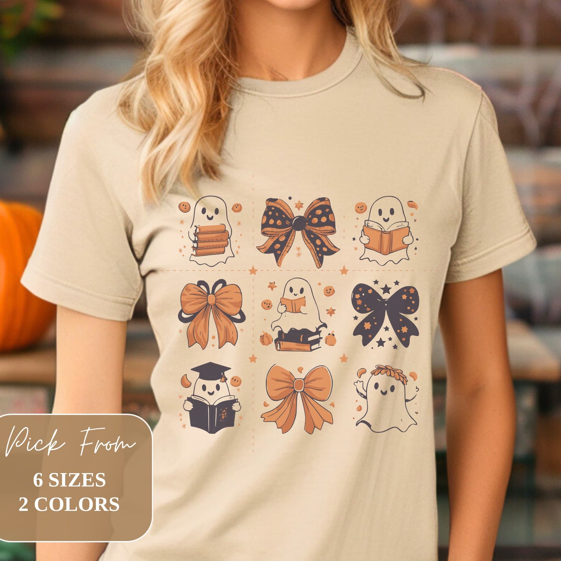 Woman wearing sand-colored t-shirt with Halloween-themed design of ghosts, bows, and books. Available in 6 sizes and 2 colors.