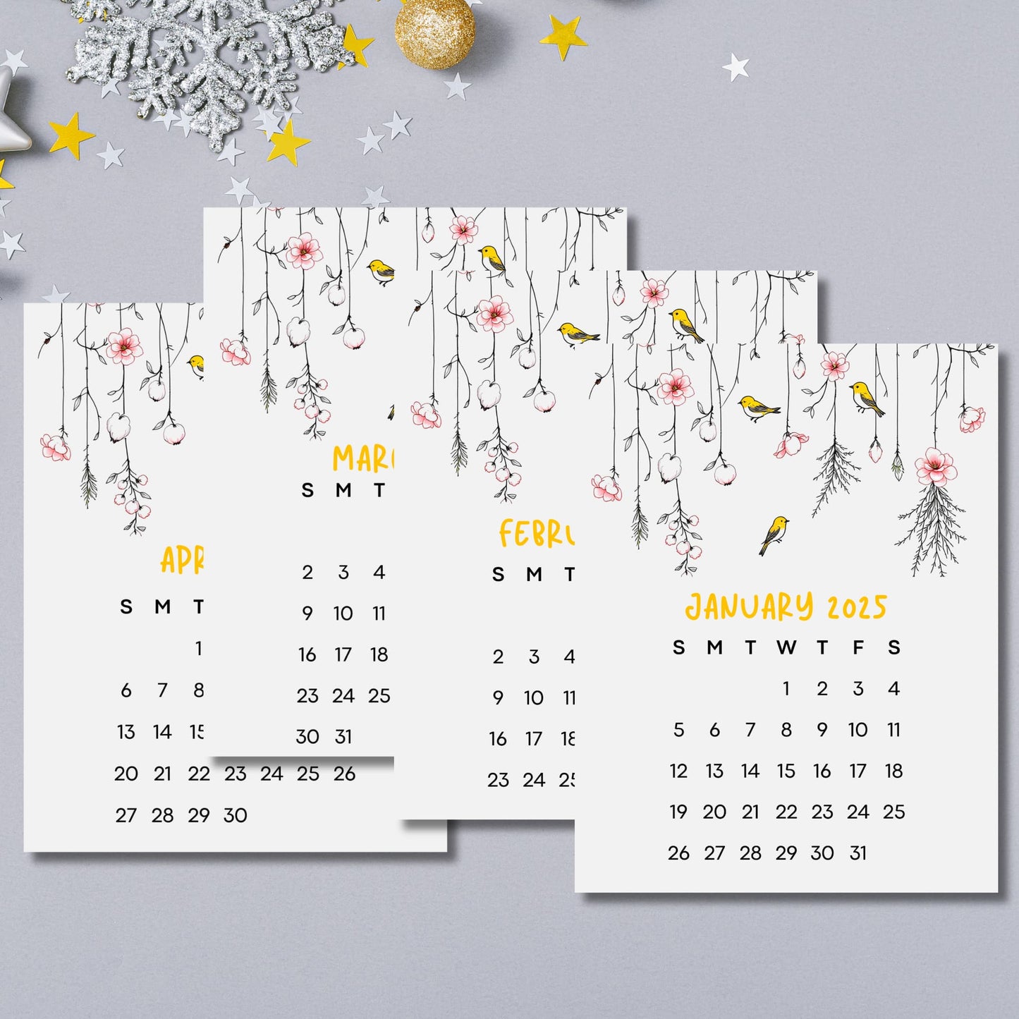 January through April 2025 calendar pages with yellow finches among dangling cherry blossoms, displayed with silver snowflake and gold star accent