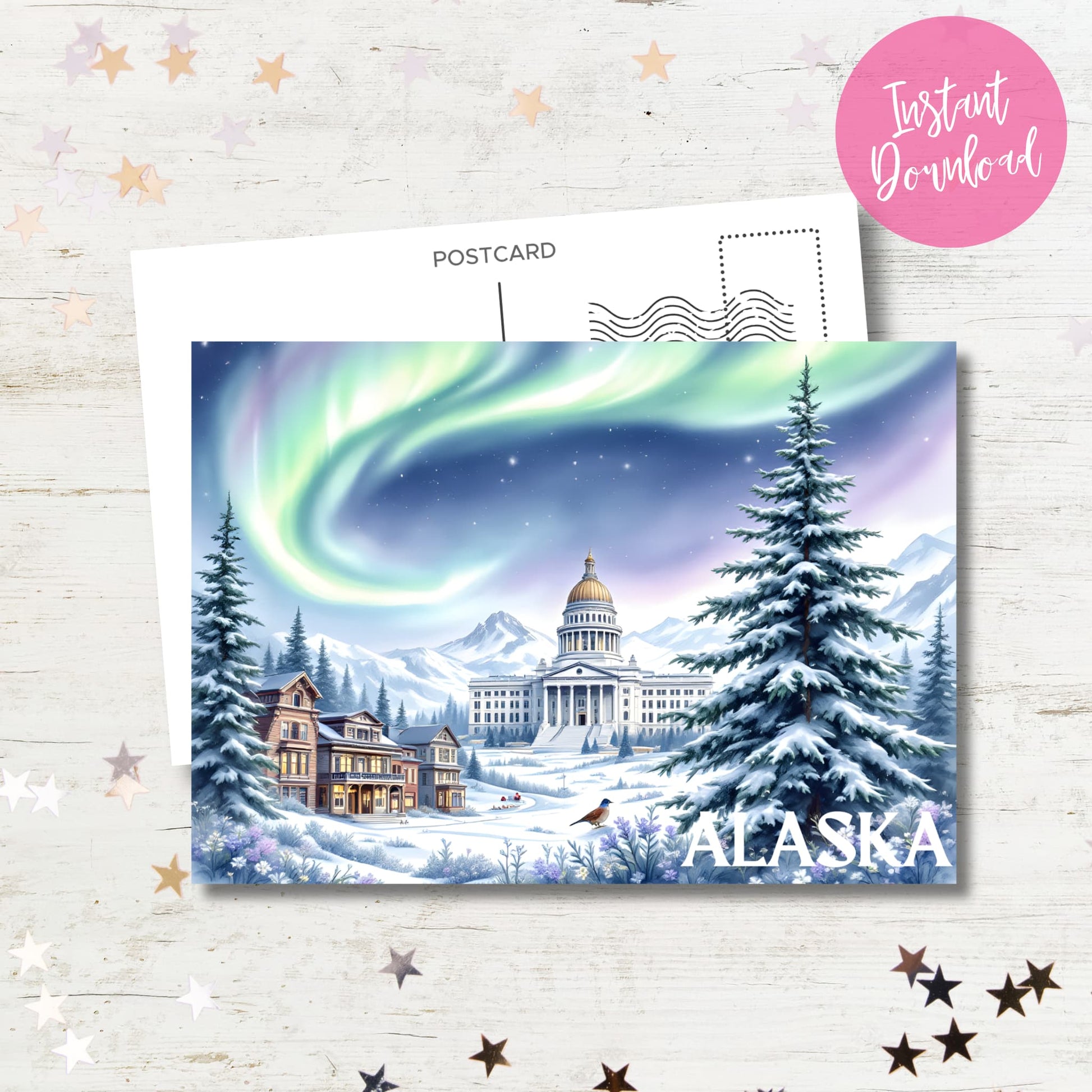 Digital Alaska winter postcard with northern lights, State Capitol and Victorian architecture in snowy landscape, displayed on rustic white background with instant download badge and decorative stars