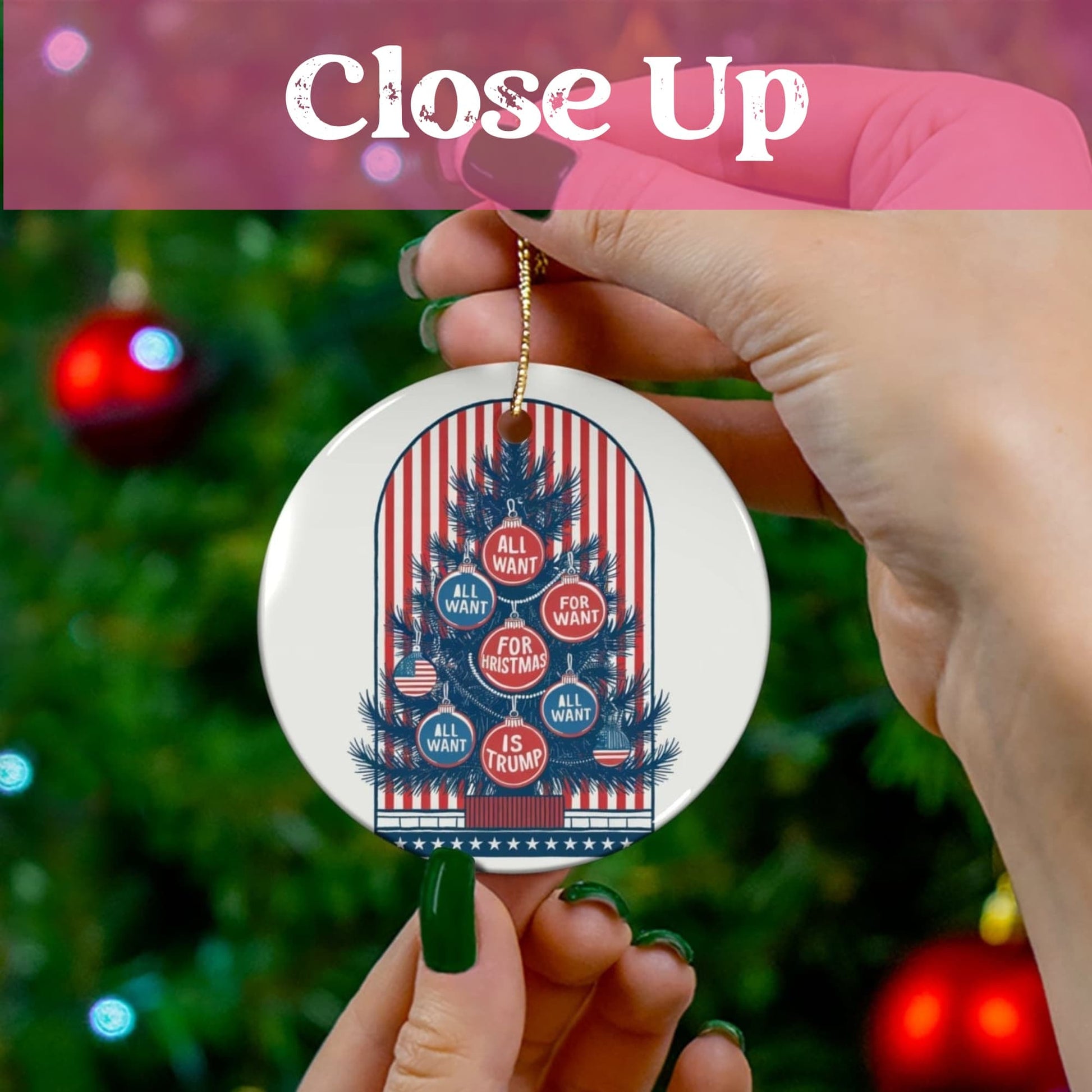 Hand-held display of ceramic ornament showing detailed patriotic tree artwork with red and blue baubles against festive green background. Gold string for easy hanging.