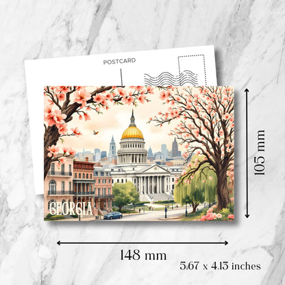 Georgia State Capitol postcard size guide (148x105mm) showcasing neoclassical architecture, pink cherry blossoms, historic brownstones, and downtown Atlanta against soft sunset