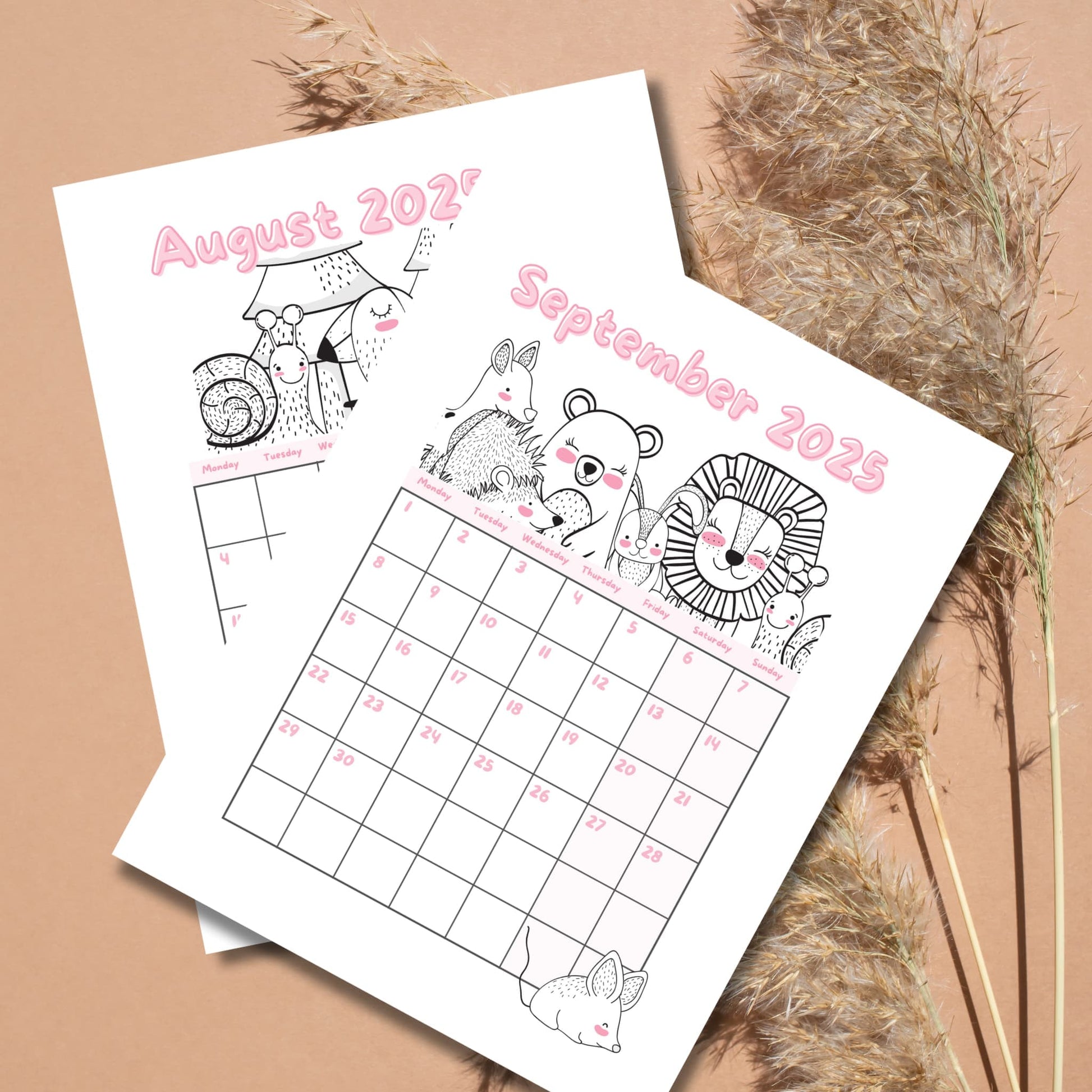 August and September 2025 calendar pages with line art woodland creatures. Pink text with Monday-start grid layout on beige background with pampas grass.