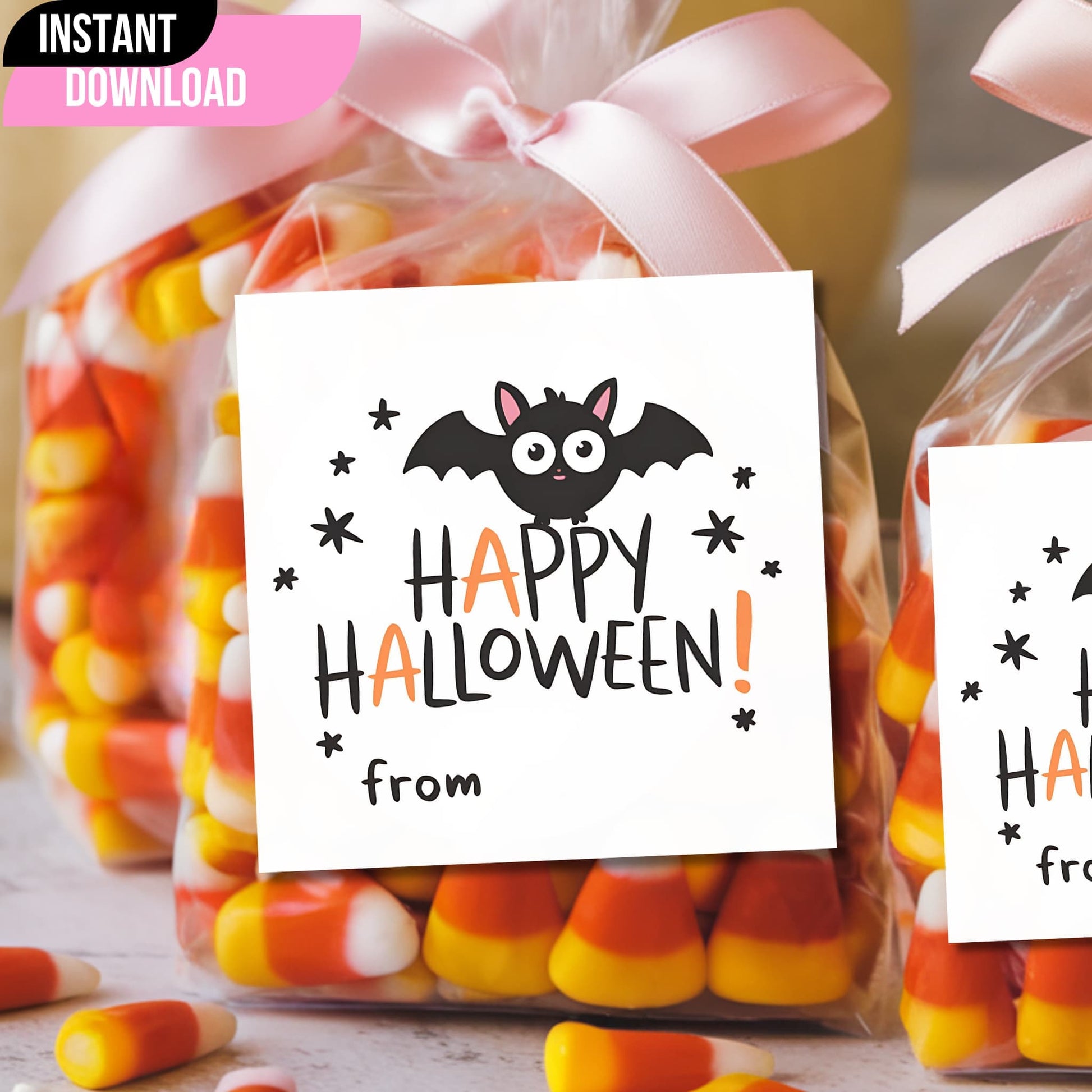 Cute bat Halloween favor tag attached to candy bag with pink ribbon, featuring "Happy Halloween" message for trick-or-treat goodies