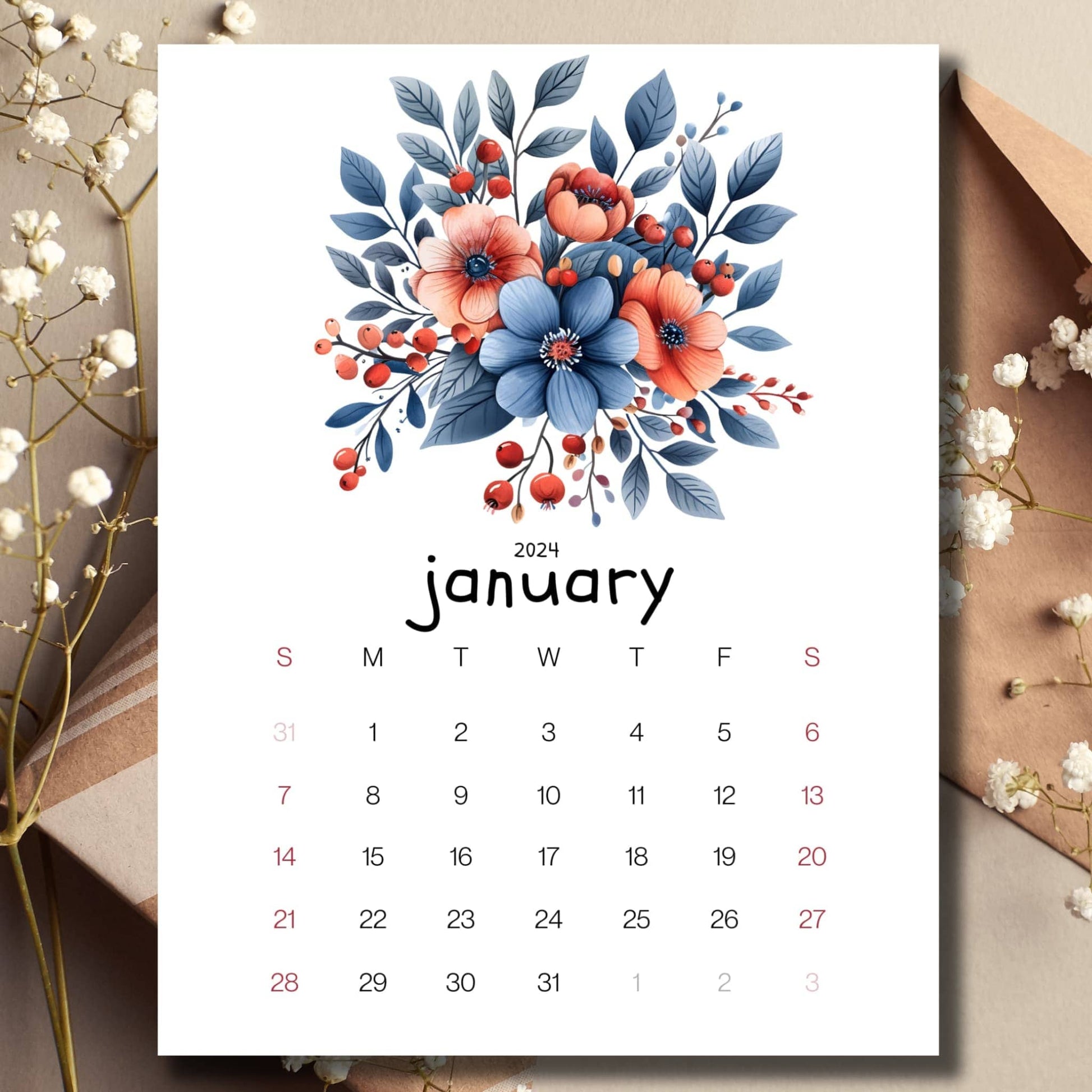 Berries and Blossoms January 2024 full year calendar page on a table with an envelope and small white flowers in the background.