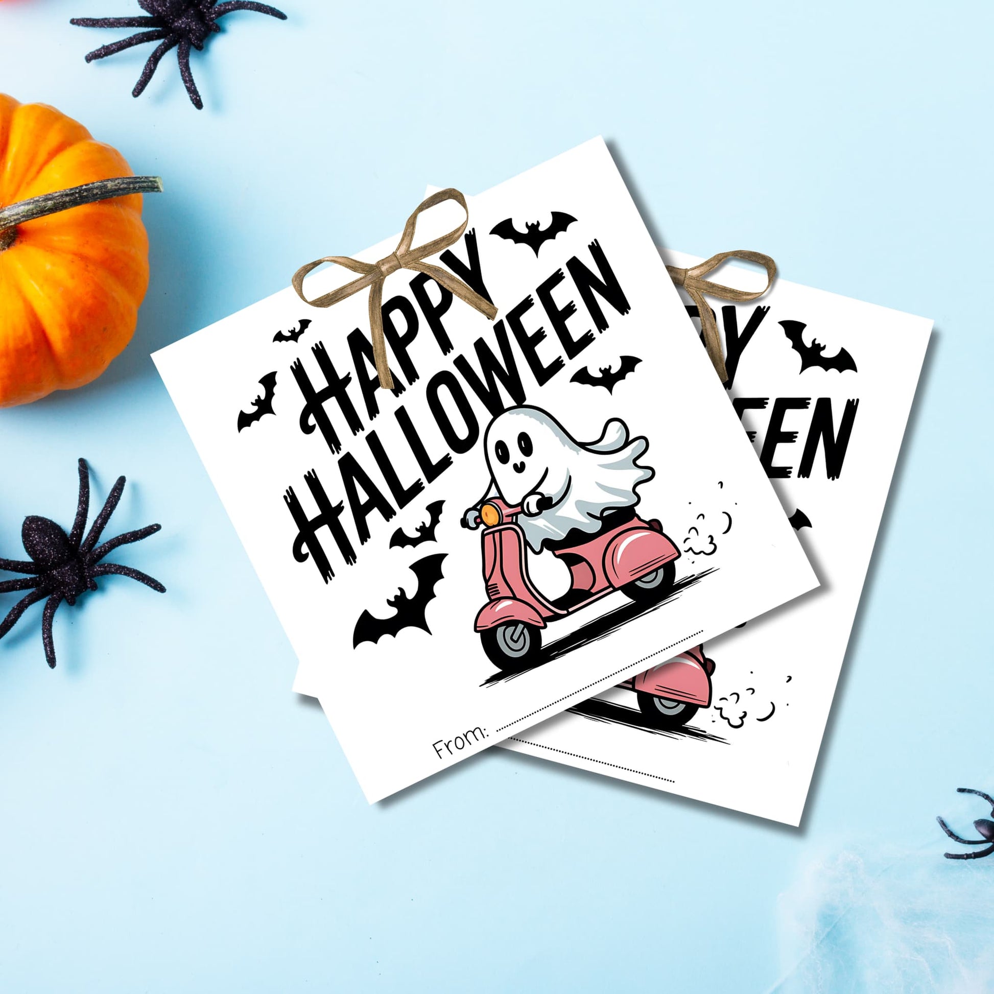 Halloween favor tags with cheerful ghost riding scooter, arranged on light blue background with festive Halloween decorations