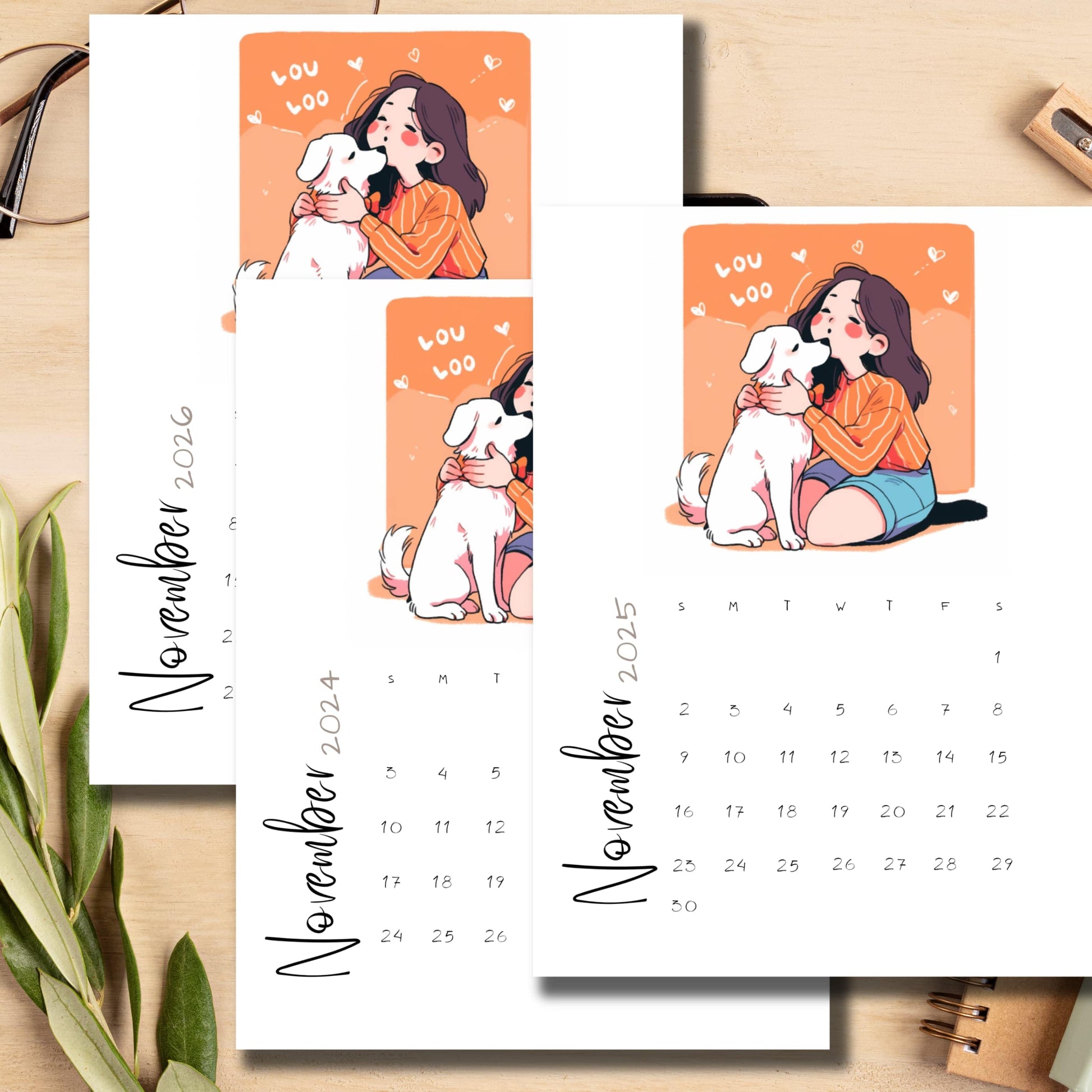 Stacked monthly calendars featuring girl hugging dog illustration, minimalist design, styled with green plant leaf on wooden background