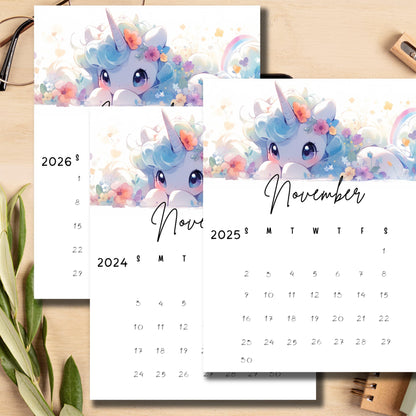 Stacked monthly calendars featuring dreamy unicorn with floral details, minimalist design, styled with green plant on wooden surface