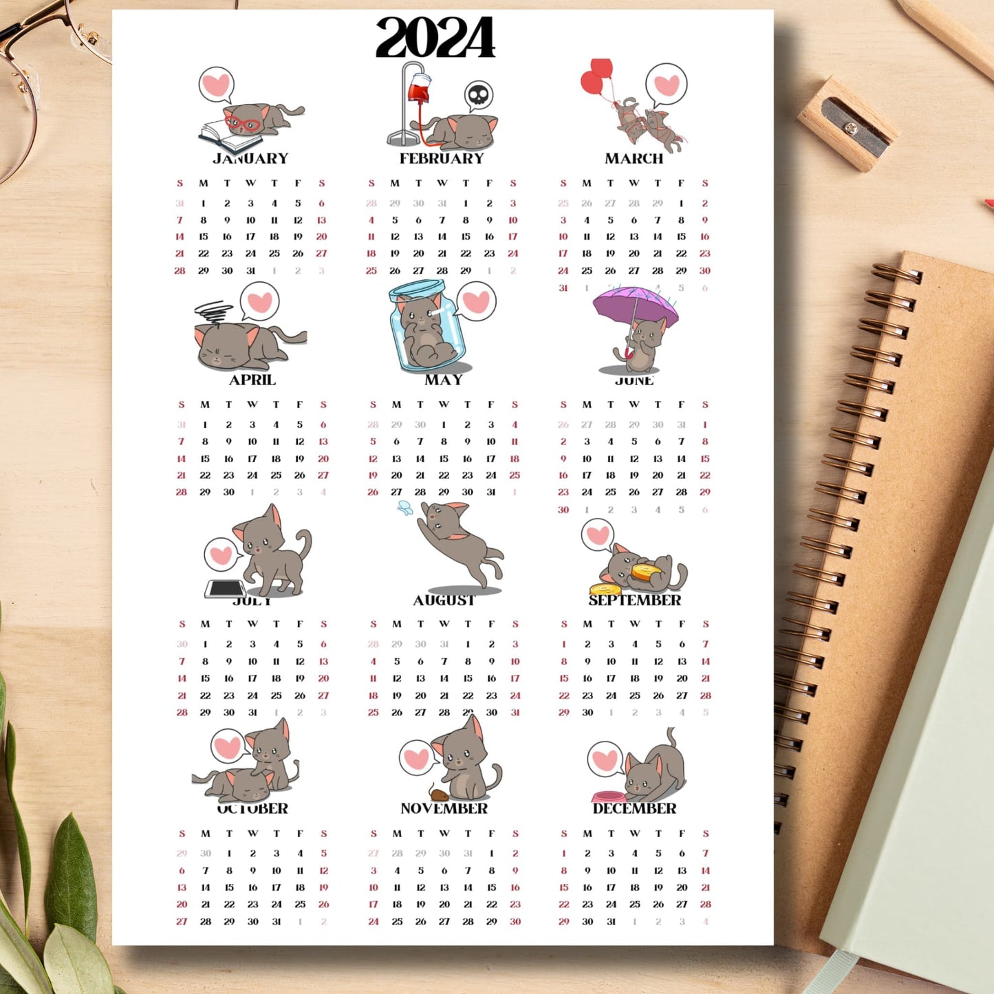 Cute cat illustrated 2024 calendar on light brown wooden desk with school supplies like notebook, pencil, sharpener.