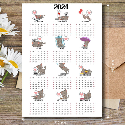 Cute cat illustrated 2024 calendar on brown wooden desk with white flowers and size guide.