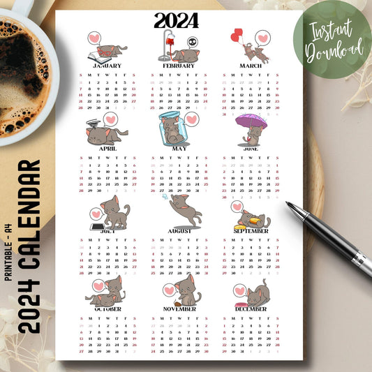 Cute cat illustrated 2024 full year calendar on brown desk with coffee cup on left and pen on right.