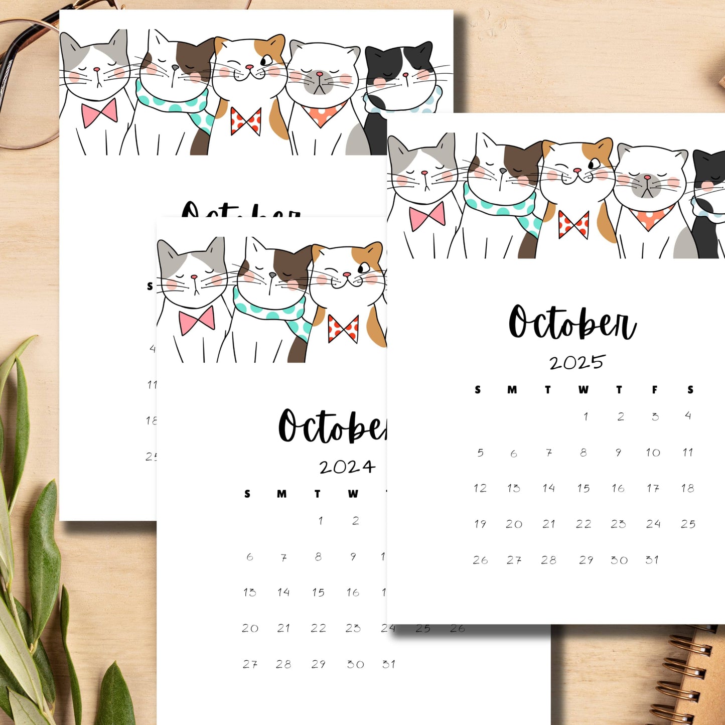 Desktop scene with October 2024 and 2025 monthly calendars featuring playful cat illustrations, displayed with glasses and plant, emphasizing the A4 size and vertical layout for easy use.