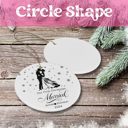 Circular white ceramic Christmas ornament showing newlywed silhouette surrounded by snowflakes, personalized with 'Annie Jhonson 2024' on rustic wooden background with pine needles