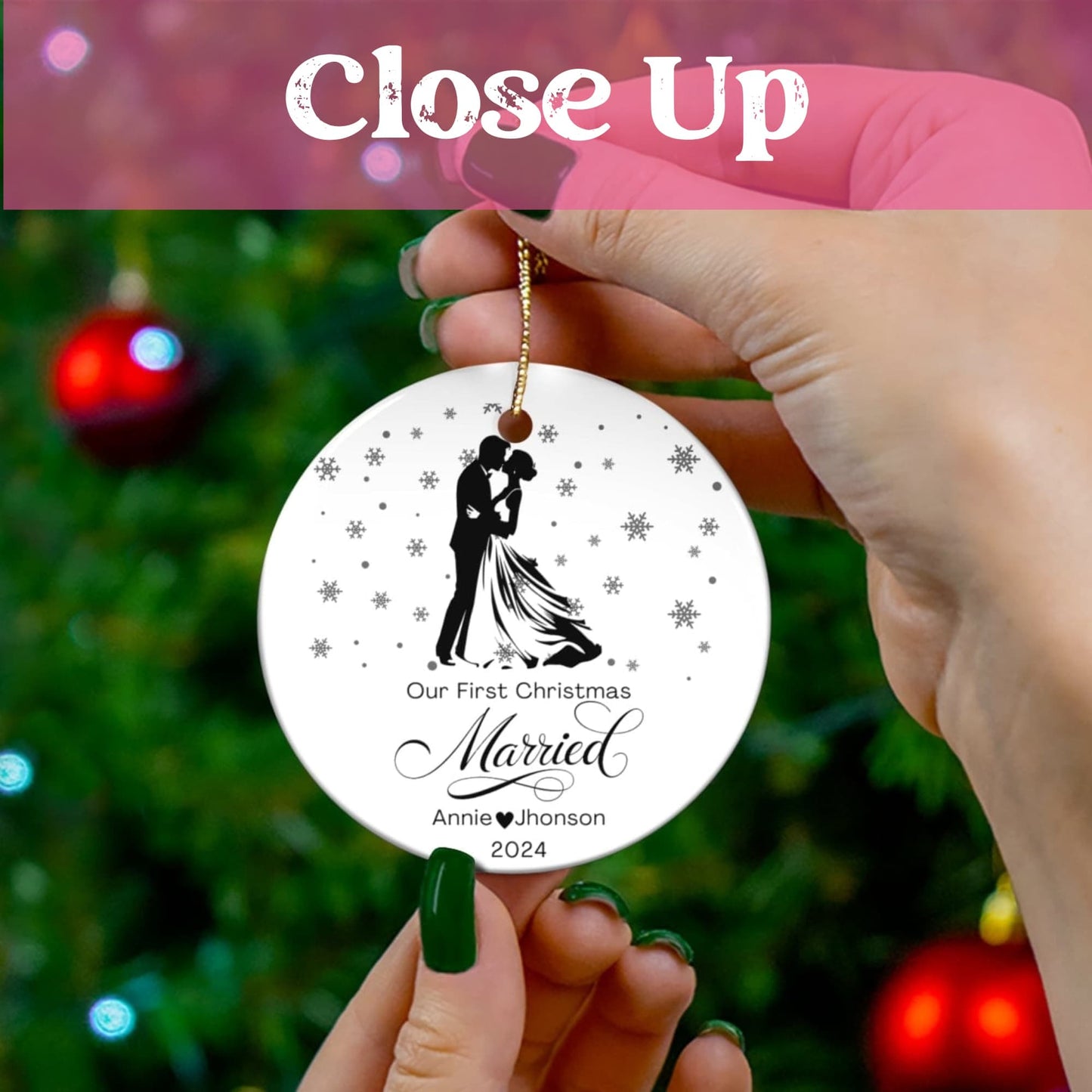 Close-up view of personalized first Christmas married ornament held against Christmas tree background, showing detailed black silhouette design and snowflake pattern