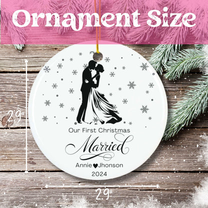 Size demonstration of 2.9-inch ceramic Christmas ornament for newlyweds, showing scale measurement with pine branch accent on wooden background