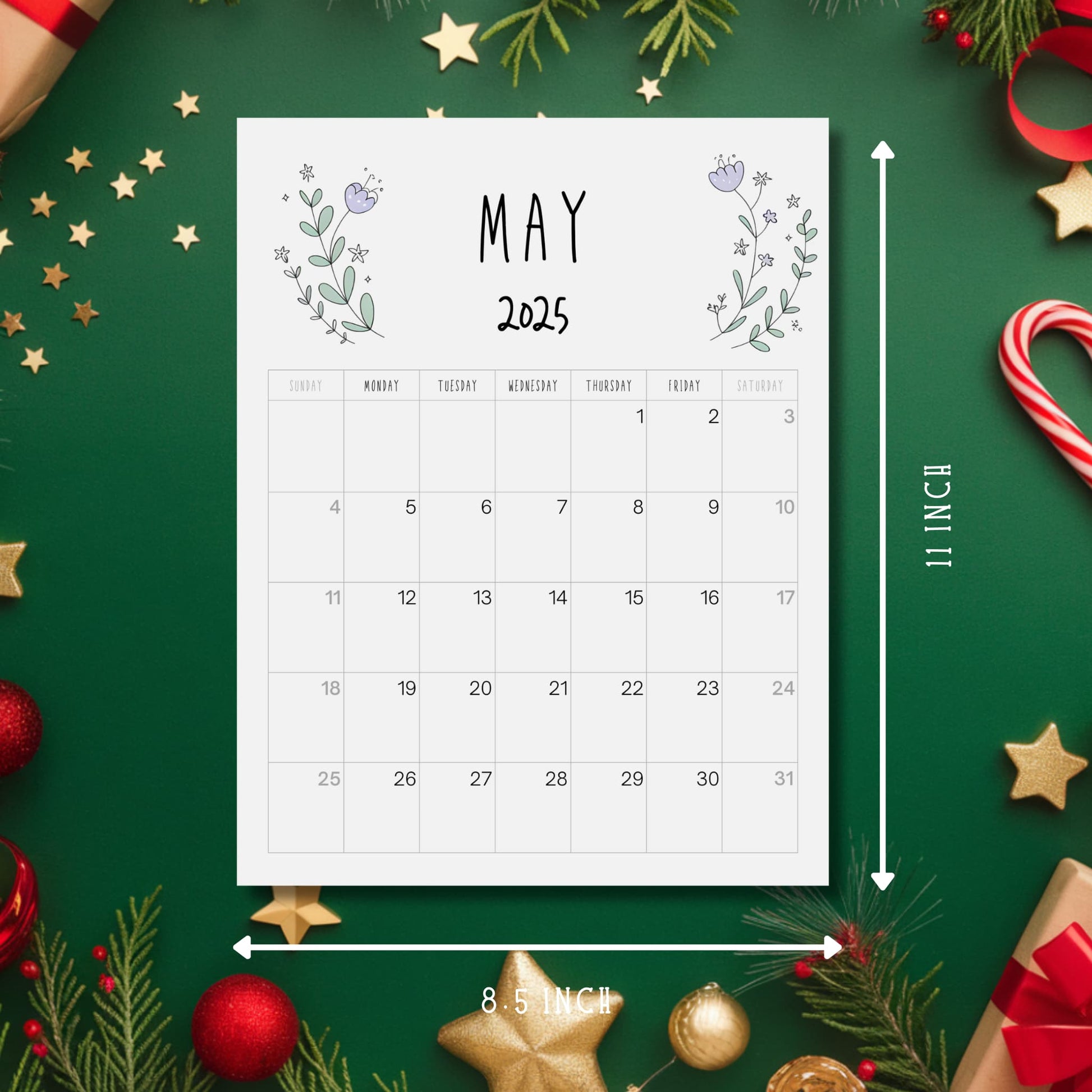 May 2025 calendar showing 8.5x11 inch dimensions, minimalist purple floral design on white, displayed with festive holiday decoration