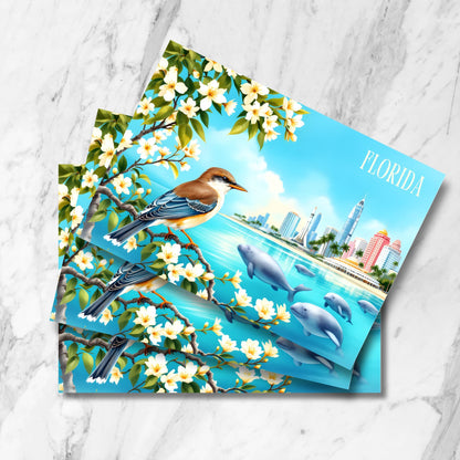 Stacked preview of Florida bay postcards showing brown songbird among orange blossoms, swimming manatees, palm-lined cityscape, and modern architecture in vintage watercolor style