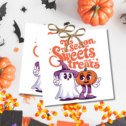 White Halloween treat tags with ghost and pumpkin friends, shown with candy corn and spooky decorations for gifting to neighbors and coworkers