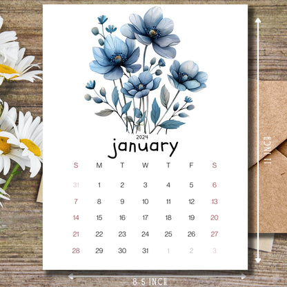 Frosty Flora January 2024 planner on a wooden desk with white flowers and a size guide on the side.