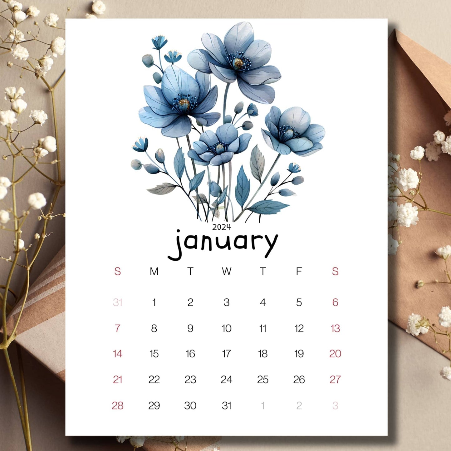 Frosty Flora January 2024 full year planner on a table with an envelope and small white flowers in the background.